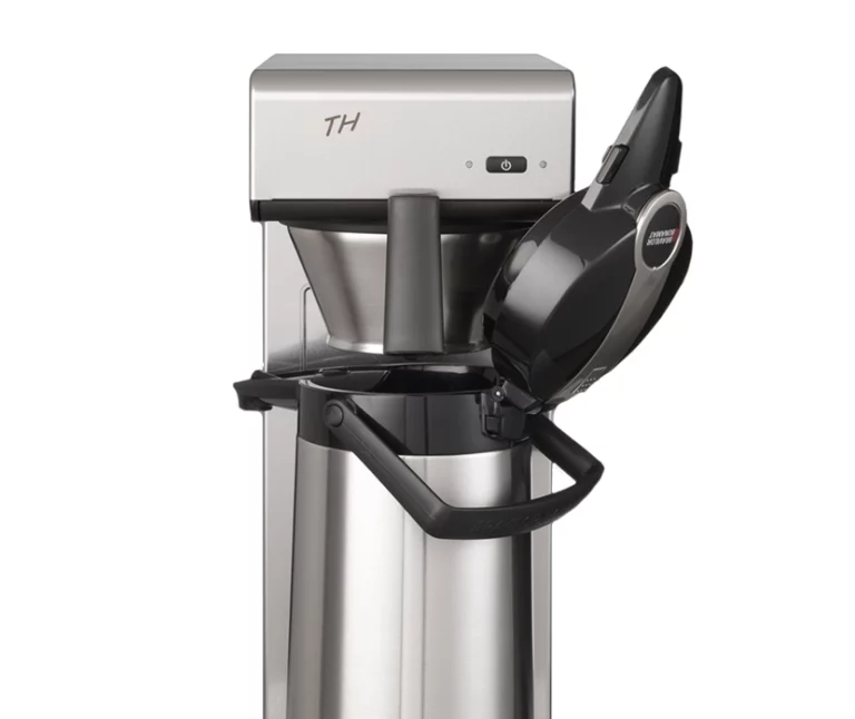 Close-up of a silver Bravilor Bonamat TH filter coffee machine with its brew head open over a stainless steel thermal airpot.