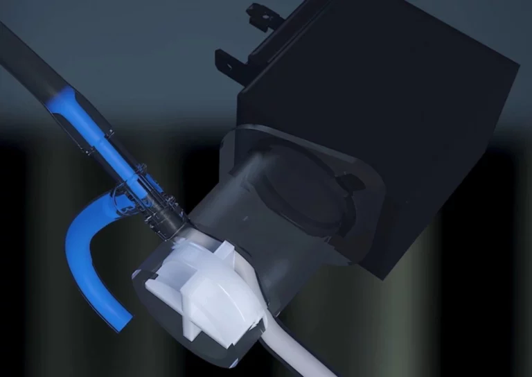 Technical 3D render of a N500 Neasa Bean to Cup Commercial internal piping. Blue fluid flows through a tube into a white mixing chamber connected to a black component.