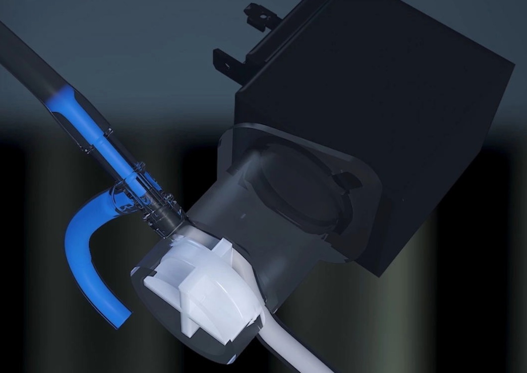 Technical 3D render of a N500 Neasa Bean to Cup Commercial internal piping. Blue fluid flows through a tube into a white mixing chamber connected to a black component.