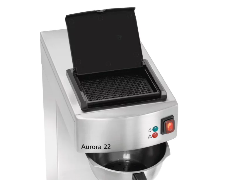 An overhead angle of the Aurora 22 thermal brewer with the top filter lid open, revealing the internal basket area and the stainless steel brew head.